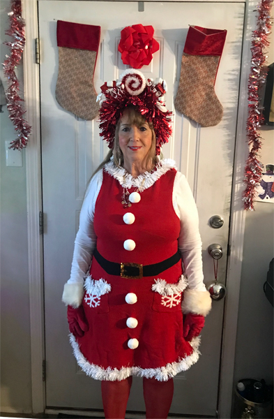Karen Duquette in a Christmas outfit and hat