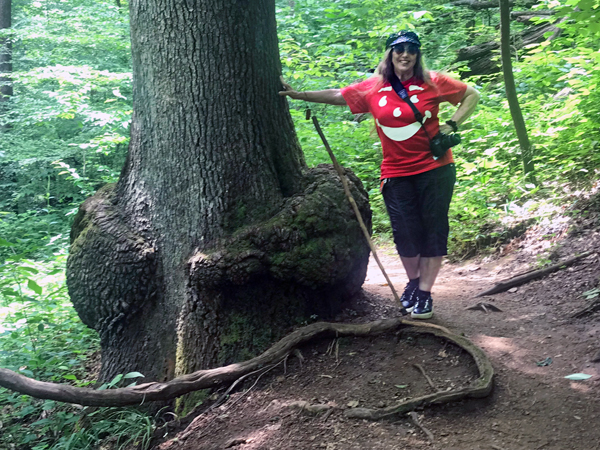 Karen Duquette by a big burl at the bottom of a very tall tree