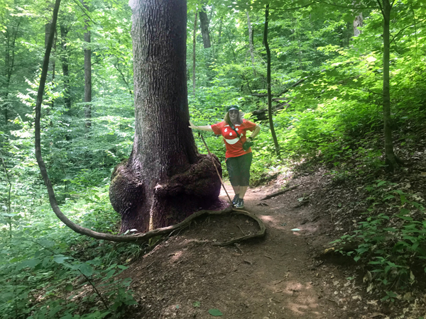 Karen Duquette by a big burl at the bottom of a very tall tree