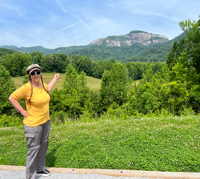 Karen Duquette pointing to Table Rock Mountain