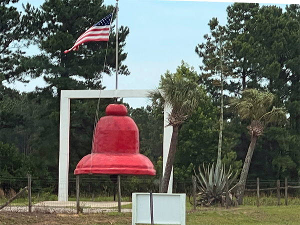 a big red bell and an American Flag