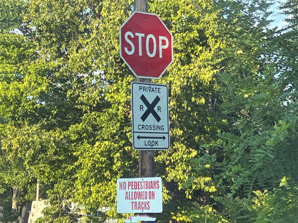 stop sign at a railroad crossing