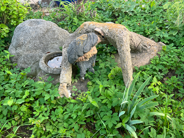 statue at Log House 1776 Restaurant Garden