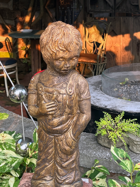 statue at Log House 1776 Restaurant Garden