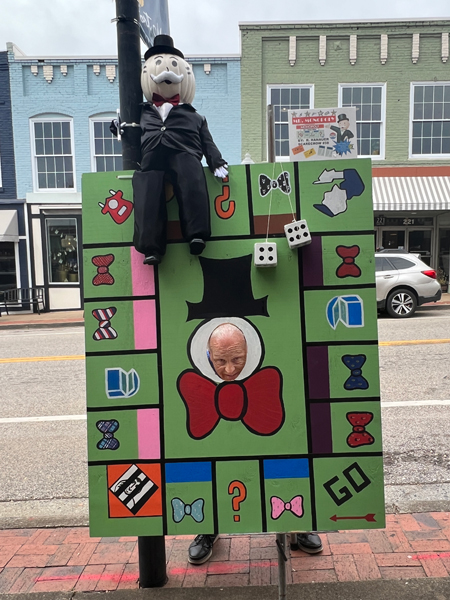 Lee Duquette with his head in an Monopoly board