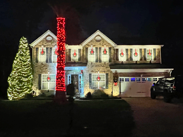 beautiful house with wreaths in windowqs