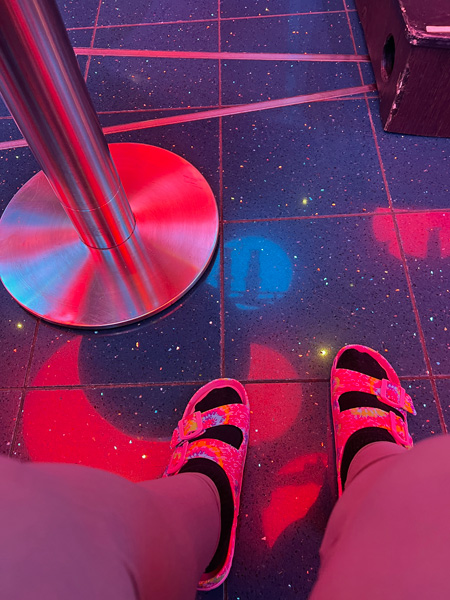 Karen Duquette's feet on a shiny floor
