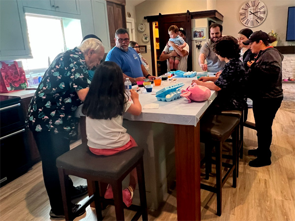 family coloring the Easter eggs