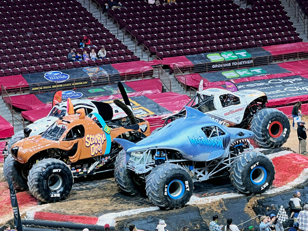 monster trucks in the center of the arena