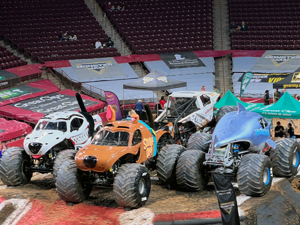 monster trucks in the center of the arena