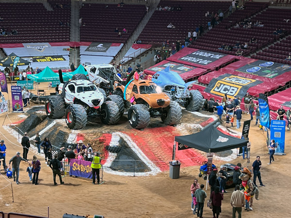 monster trucks in the center of the arena