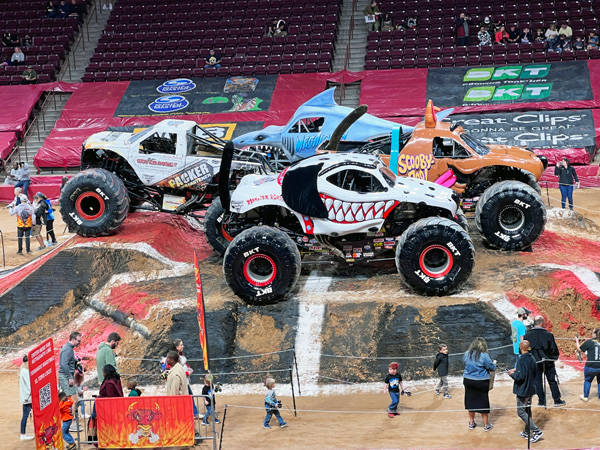 monster trucks in the center of the arena