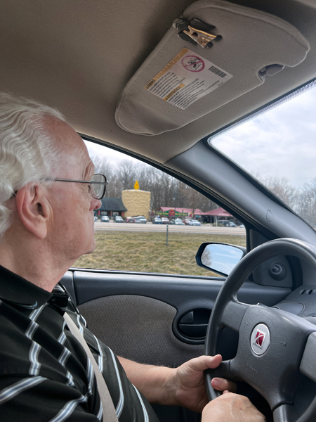 Lee Duquette driving by  a very big candle