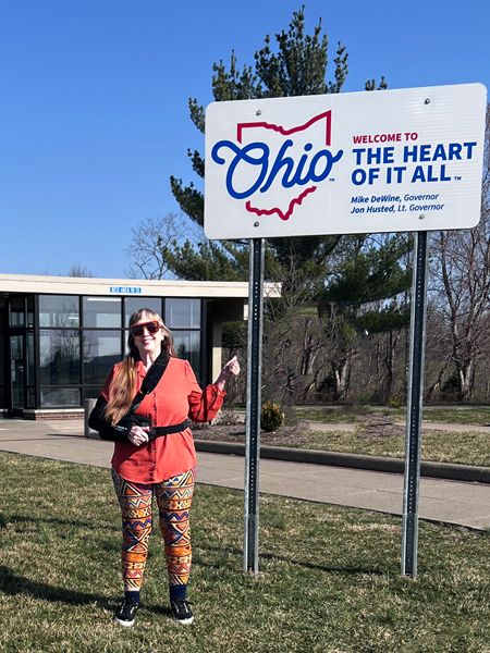 Karen Duquette at the Welcome to Ohio sign