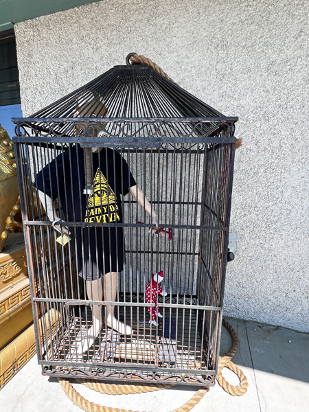 caged person and puppet clown
