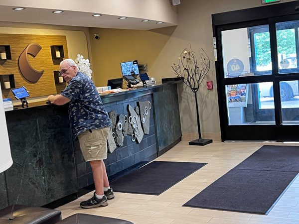 Lee Duquette waiting to check in at the hotel