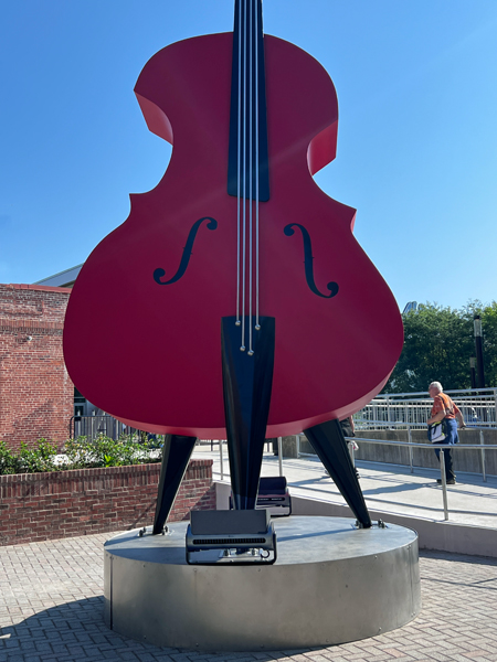 Lee Duquette behind a giant guitar