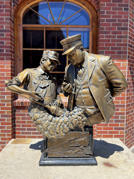 comparing sign statue