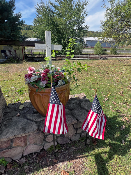 cross, flowers and USA flags