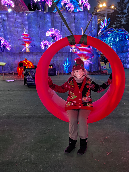 Karen Duquette on a  red swing