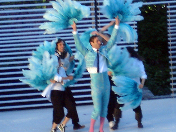 male performer with feathers