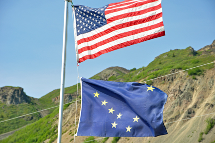 the American Flag and the Alaska flag in front of our RV