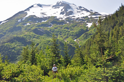 Lee is dwarfed by the mountains and trees