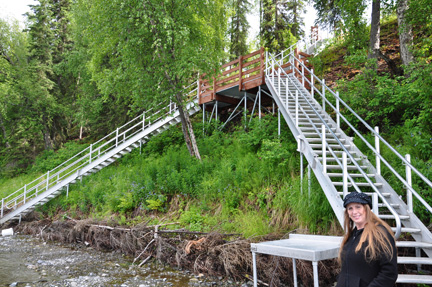 Karen Duquette at the bottom of the stairs