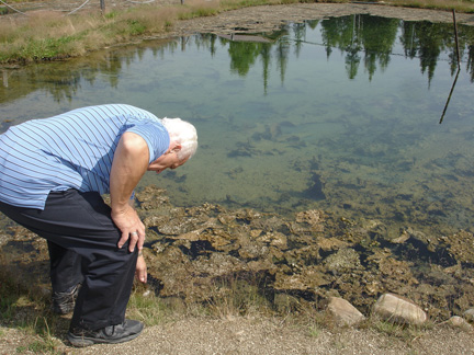 Lee checks out the temperature of the pond