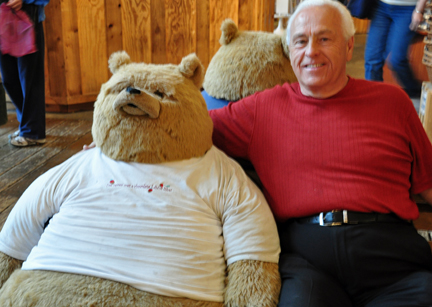 Lee Duquette and a stuffed bear realaxing in the gift shop