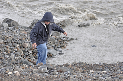 Alex plays with the rocks