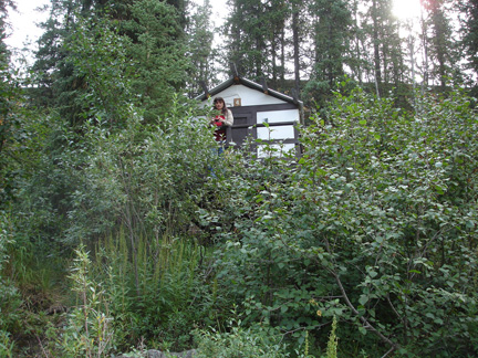 Renee by a cabin up the hill