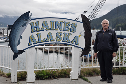 Lee Duquette and a Haines Alaska sign at the pier