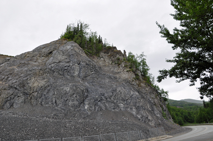 the road curves around a big rock