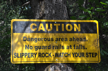 sign - caution - no guard rails at falls