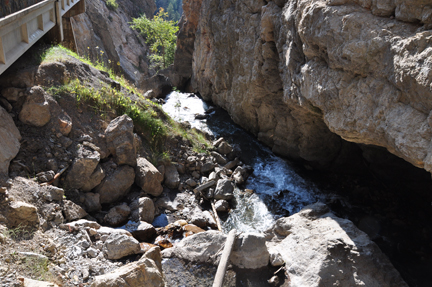 looking down the side of the cliff to see the springs