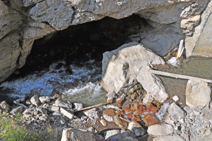 looking down the side of the cliff to see the springs