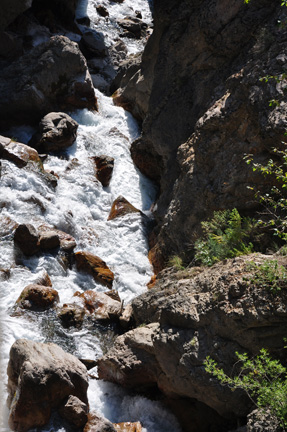 looking down the side of the cliff to see the springs