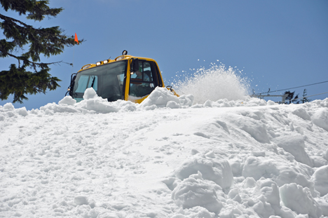 A SNOW PLOW HARD AT WORK ON GROUSE MOUNTAIN