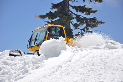 A SNOW PLOW HARD AT WORK ON GROUSE MOUNTAIN