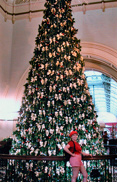 Karen Duquette and a tall Christmas tree