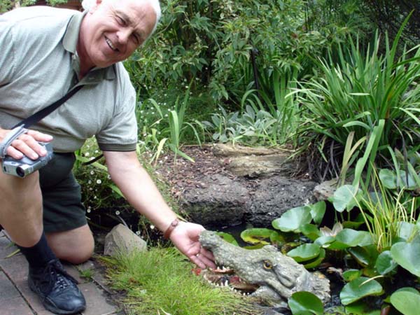 Lee Duquette  touching an alligatot