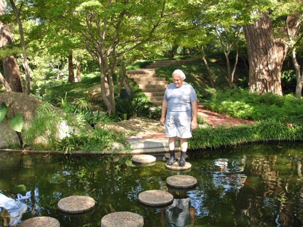 Lee Duquette crossing the stone path over water