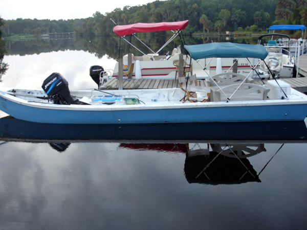 a weird boat with the engine in the bow 