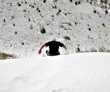 Lee Duquette sliding down the white sand dune