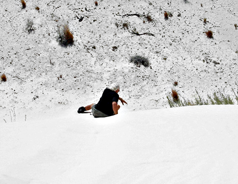 Lee Duquette sliding down the white sand dune