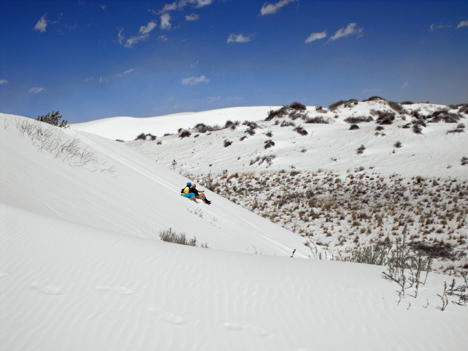 the two RV Gypsies sliding down the white sand dune