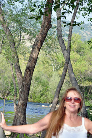 Karen on the beach enjoying a view of the river & the mountain 