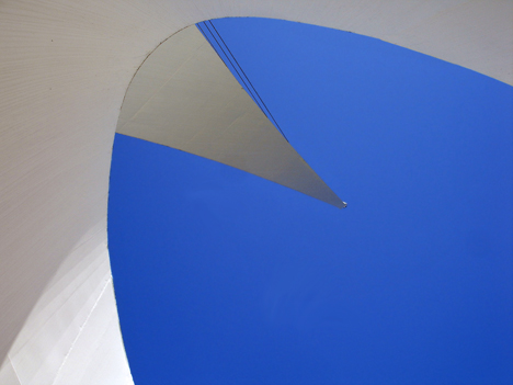 looking up at the sky and the pylon from under the bridge