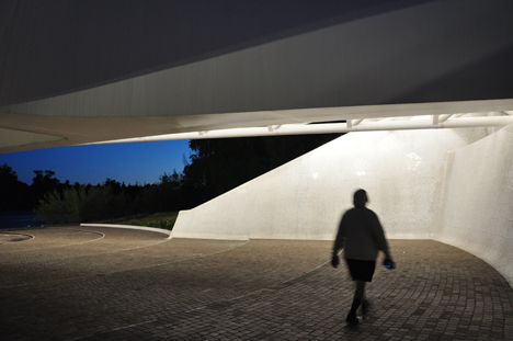 Lee walks under the bridge to look up at the pylon